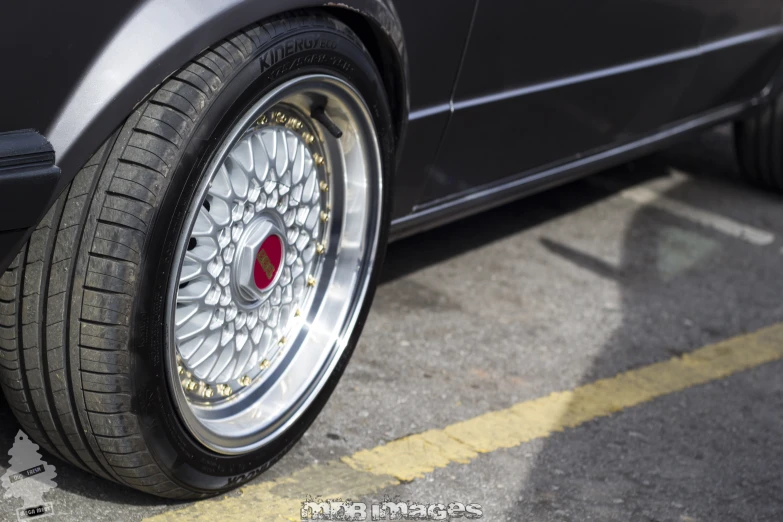 a car tire is on display with other vehicles