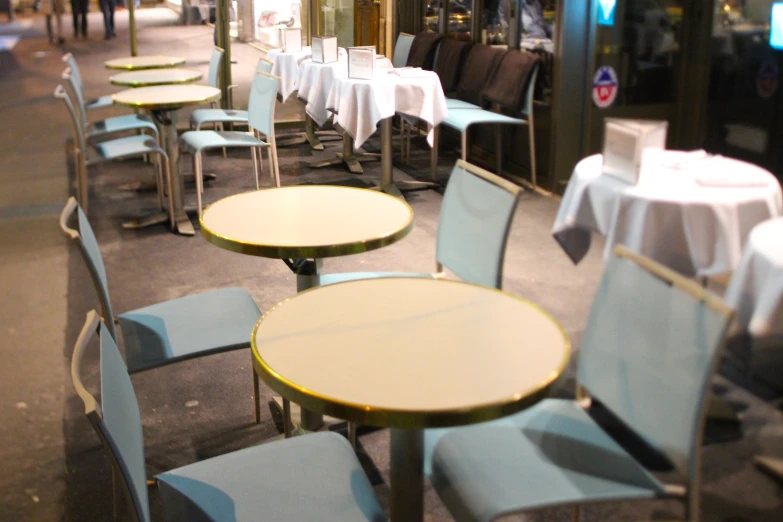 rows of chairs and tables with white tablecloth