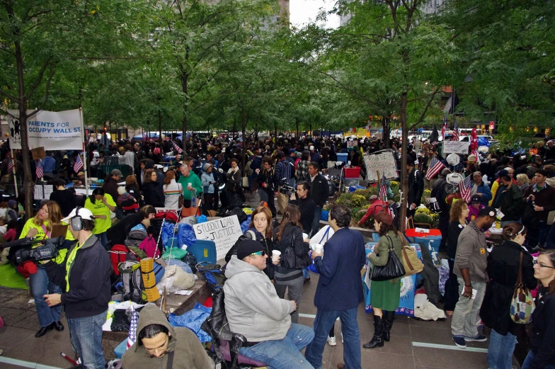 hundreds of people gathered together on the street