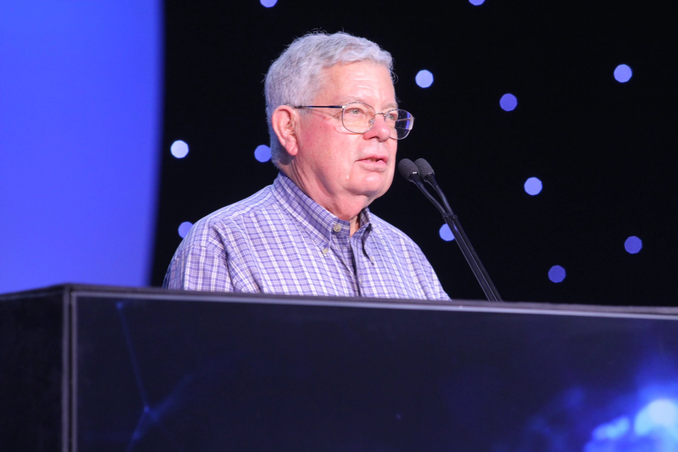 a man is giving a speech from a podium