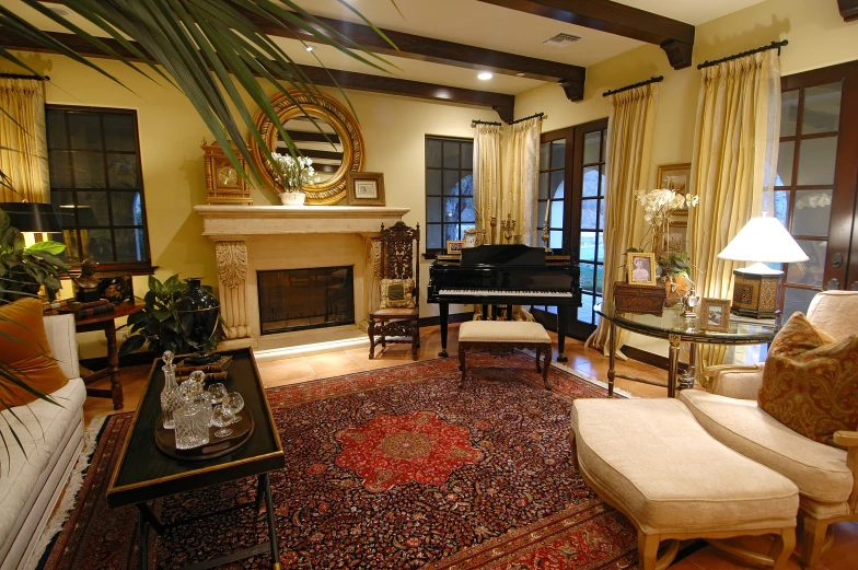 a living room with a couch, ottoman and piano