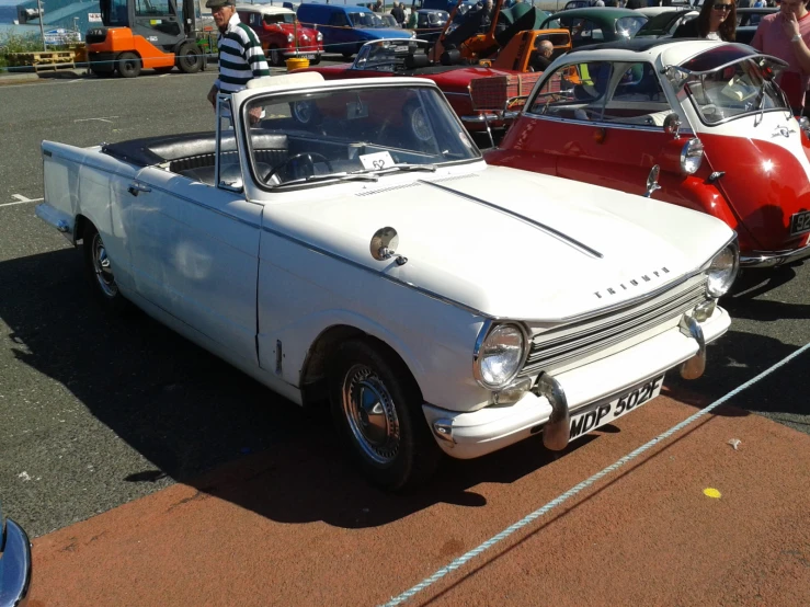 there is an old fashioned car on display in the parking lot