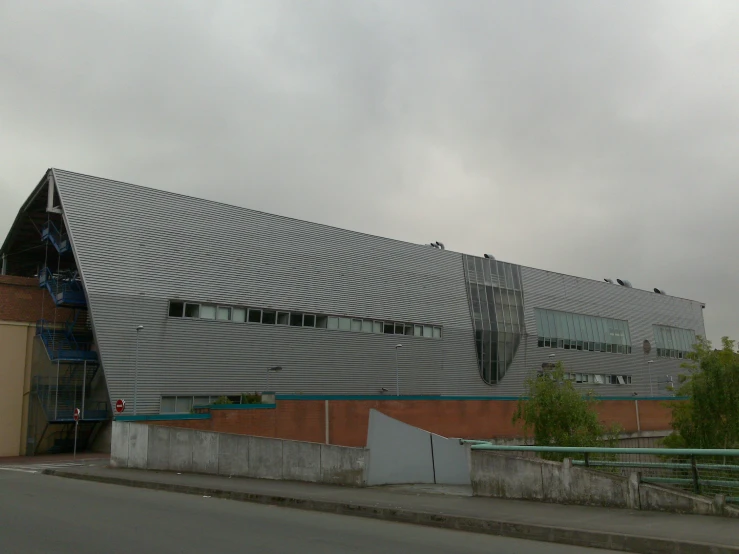 an architectural building stands in front of a cloudy sky