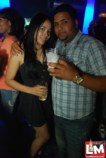 a man and woman pose for a po at a party