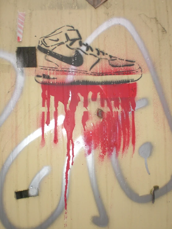 graffiti on wall that depicts a shoe on top of an object