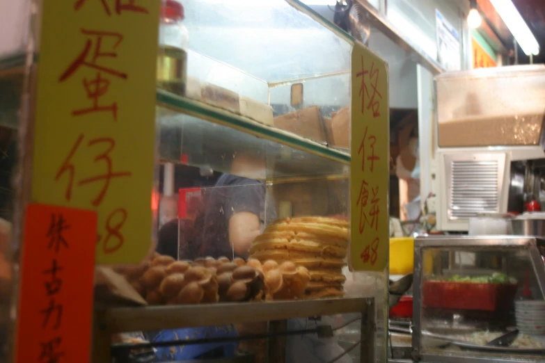 a store filled with a display of various kinds of pastries