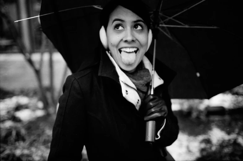 a woman wearing an umbrella, hat and holding an umbrella