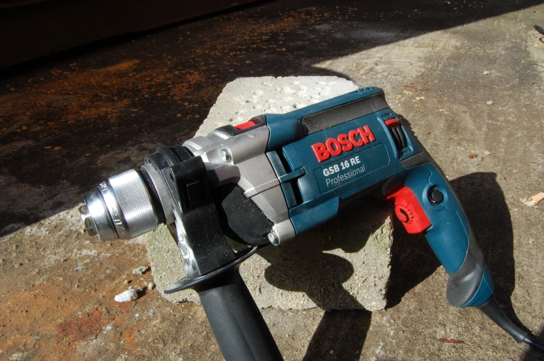 a bosch rotary demolition tool sits on a sidewalk