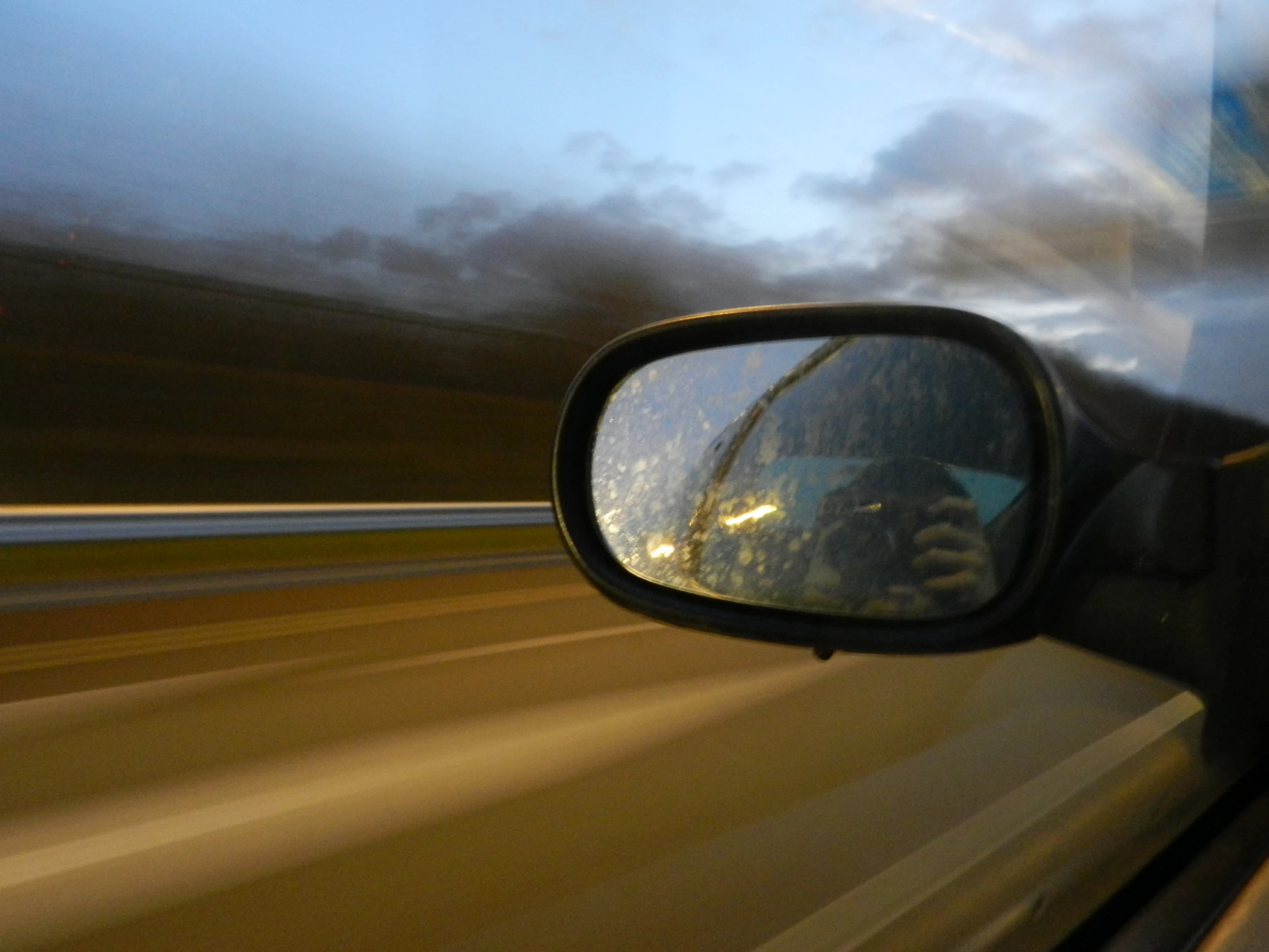 the rear view mirror on a vehicle is reflecting a person