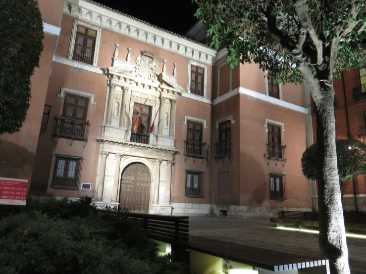 a building with an open door and stairs next to it