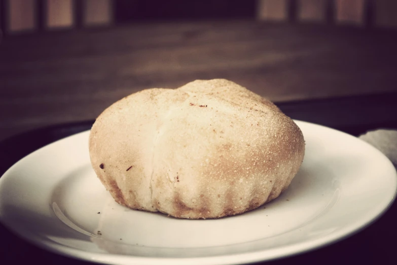 a pastry sitting on a white plate ready to eat