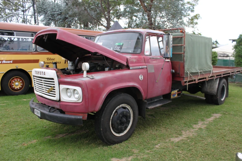 a flatbed truck with its hood open