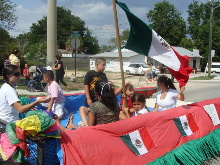 people standing around in a float with a flag on it