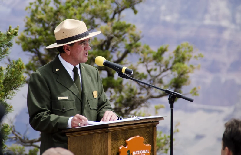 a man in uniform stands at a podium while speaking