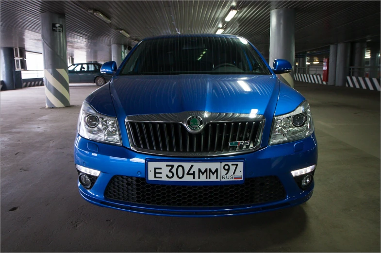 a blue car that is parked in a garage