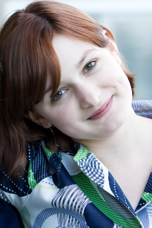 a woman wearing a shirt and tie in close up