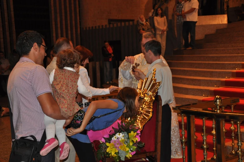 a crowd of people standing around a bunch of stairs