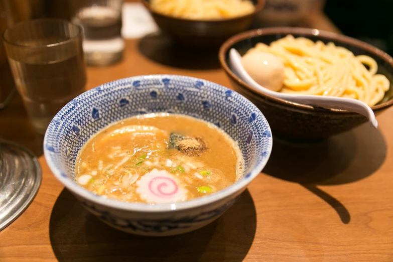 two bowls of food that have pasta on them