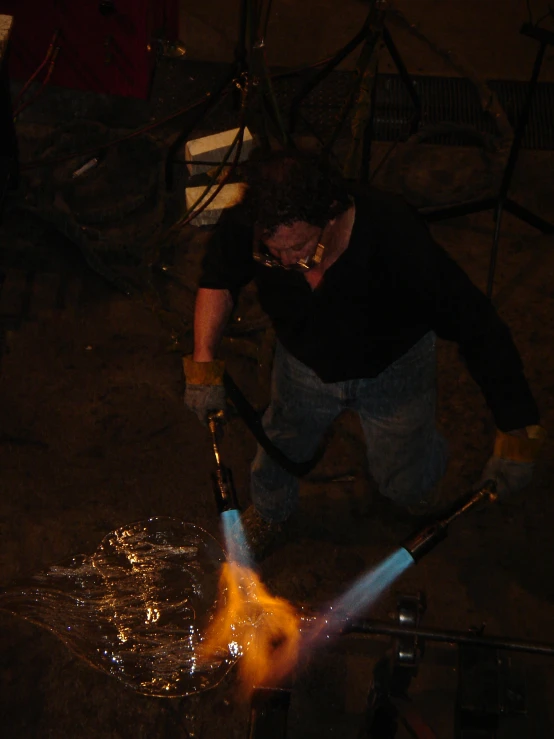 a person working with a pair of welding hoses