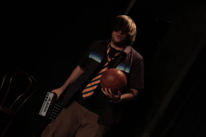 a man holding an orange ball on top of a basketball