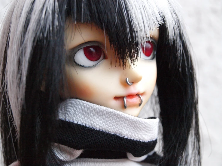 doll with dark hair wearing black and white sweater