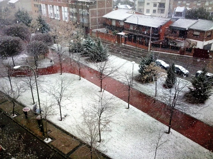 an overview of a snowy park and a street
