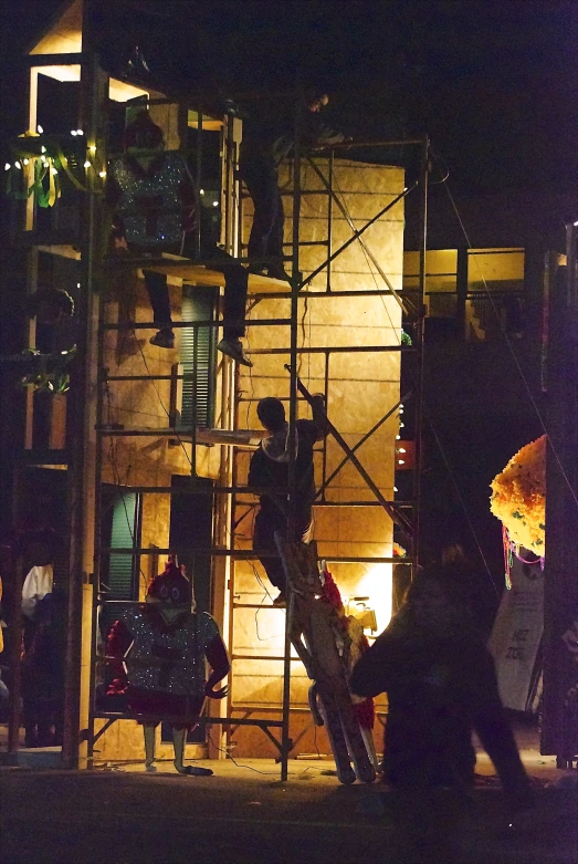 a group of people climbing up onto a tall building