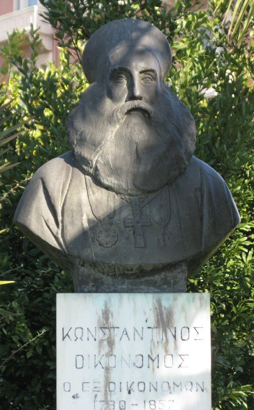 a bust of an old gentleman holding a sign