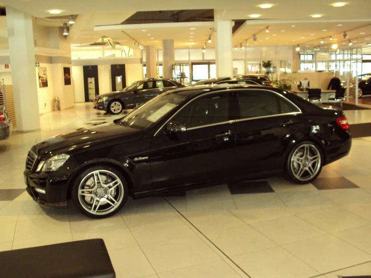 a black mercedes is parked inside a mall