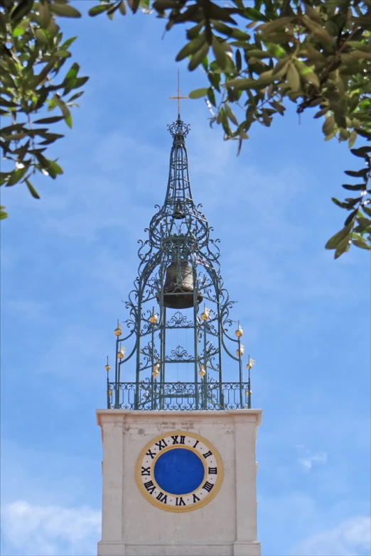 the tower with the golden clock has a blue circle underneath it