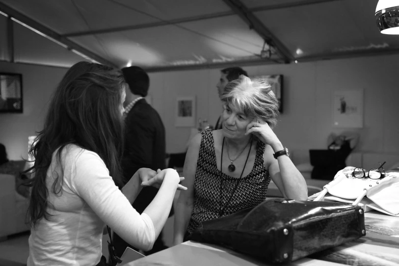 a woman is putting on her jewelry in the mirror