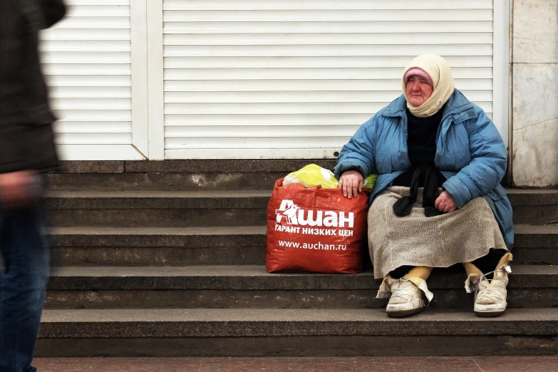 a woman is sitting down on a step