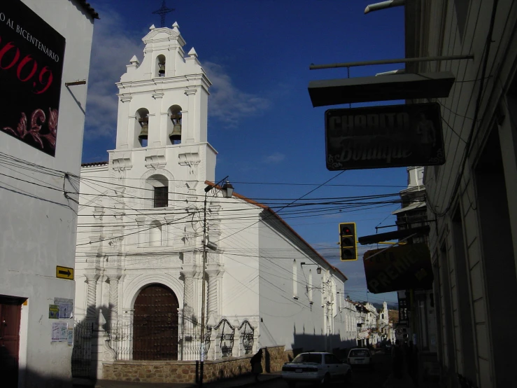 this is an old church in a town with cars parked