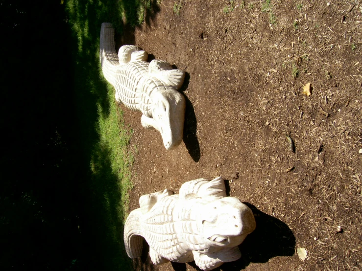 two large white plastic elephants standing next to each other