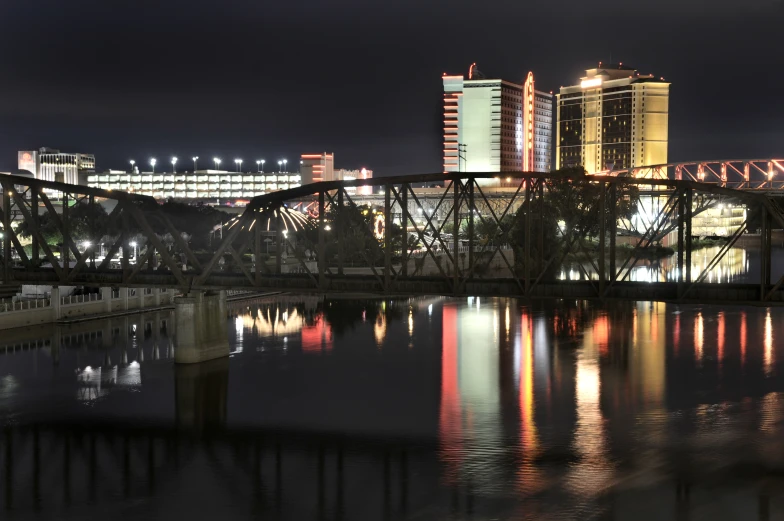 some buildings water lights and a bridge