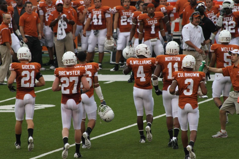 a football game with several players walking on the field