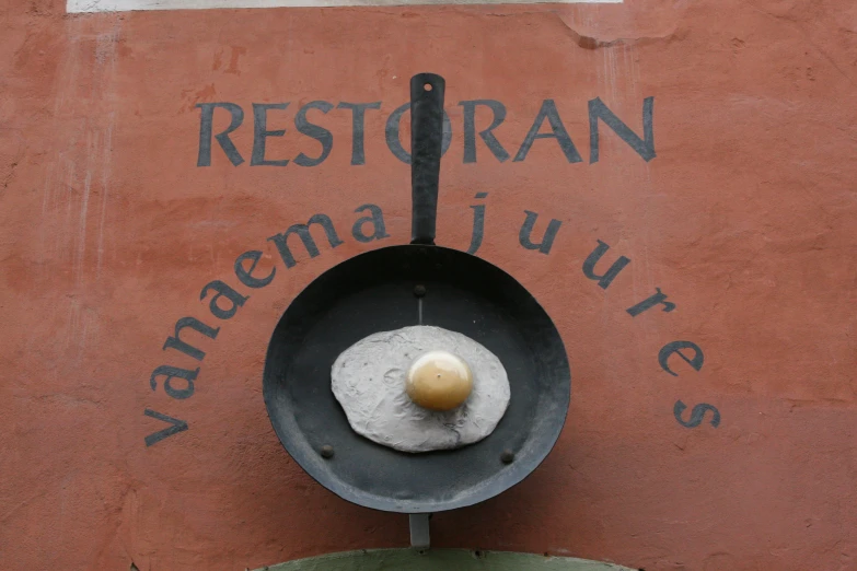 a small frying pan with a hard cooked egg on top