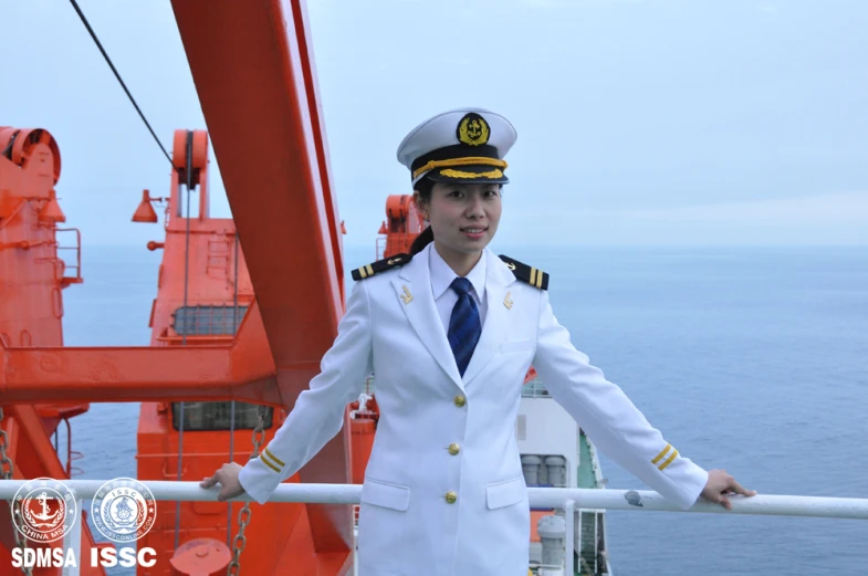 an officer stands on the deck of a ship