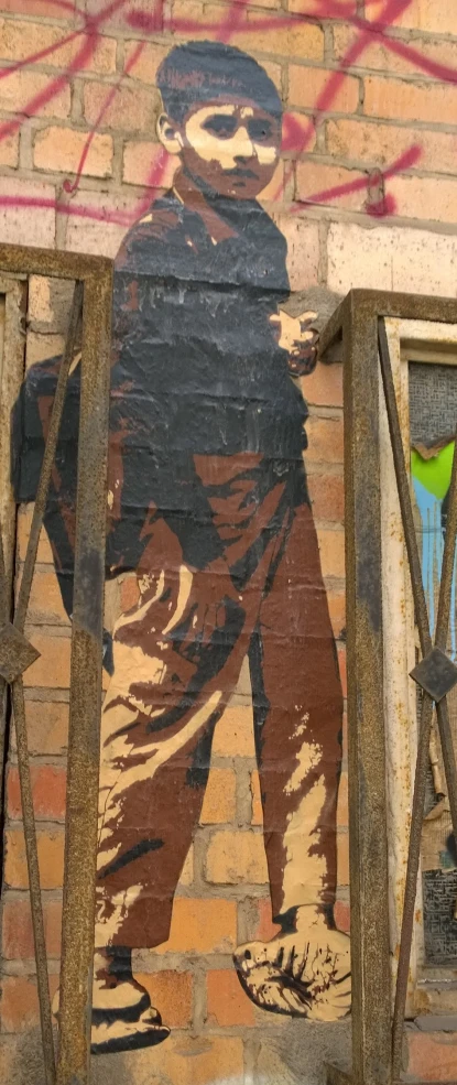 a man is holding on to the bars painted on a wall