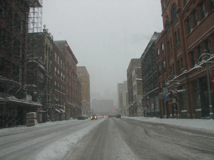 a snowy city street with a number of buildings