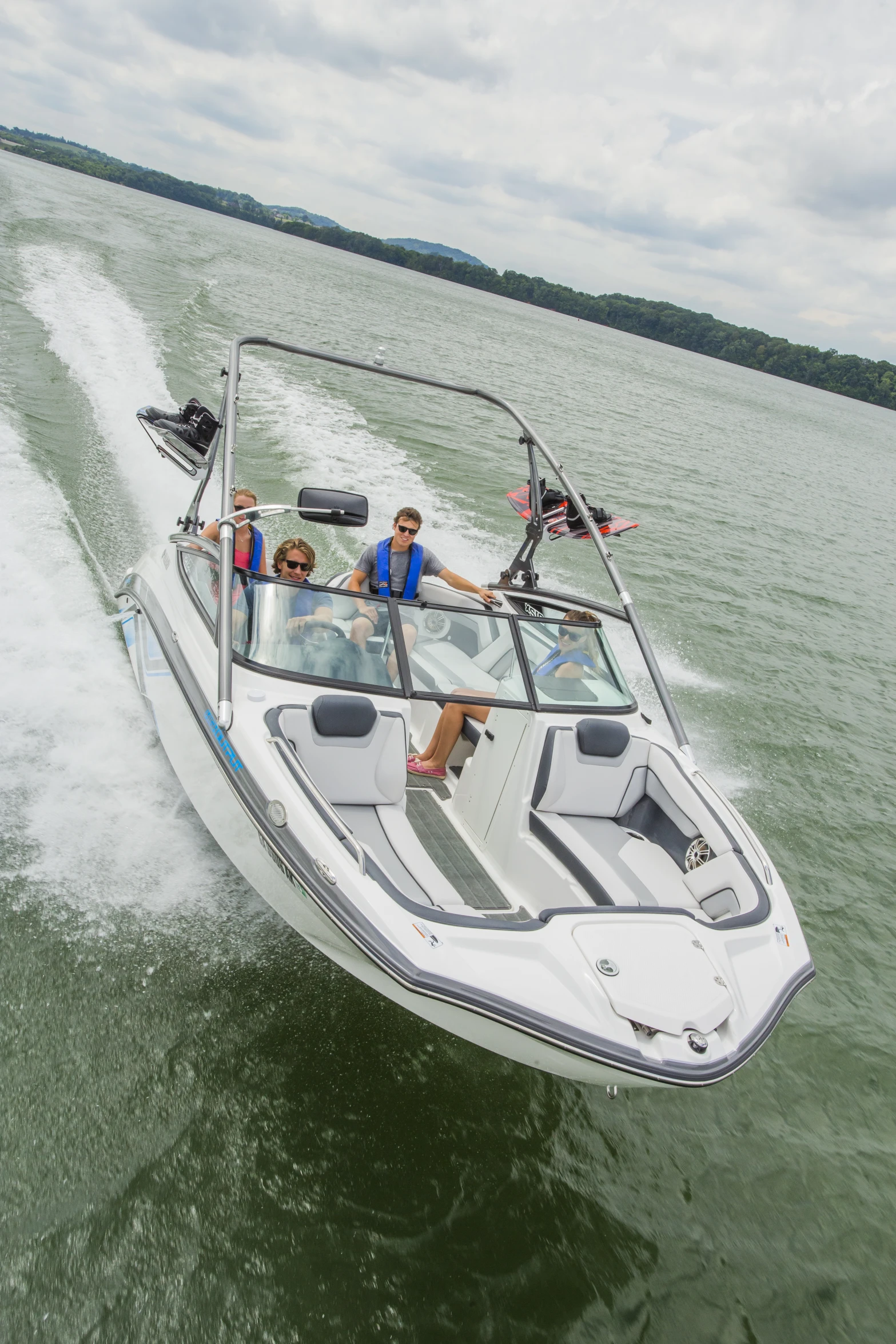 two people riding on the back of a boat