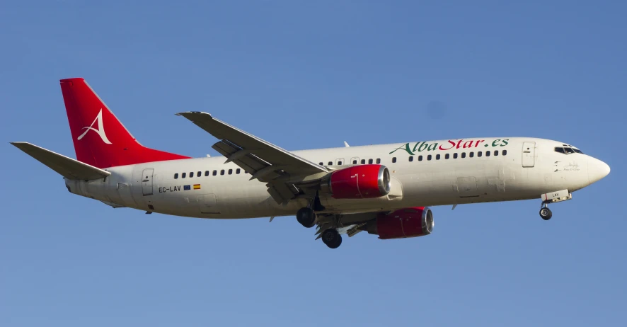 the airliner is painted red and white on its tail