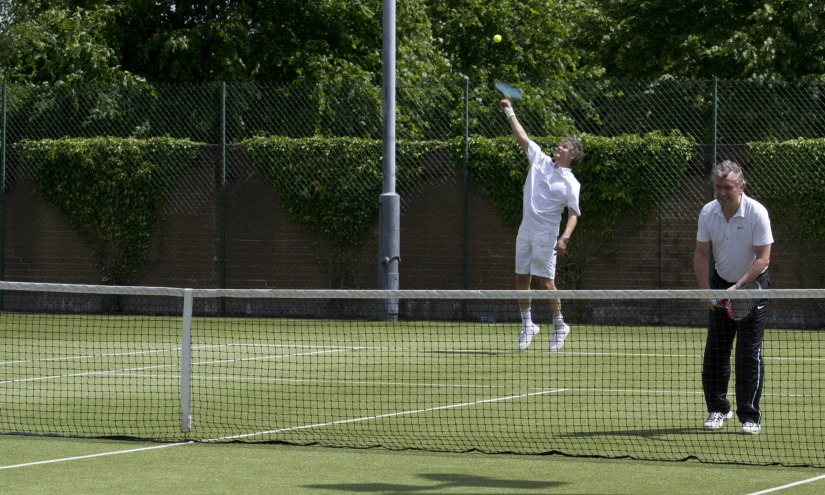 two people playing tennis on the court