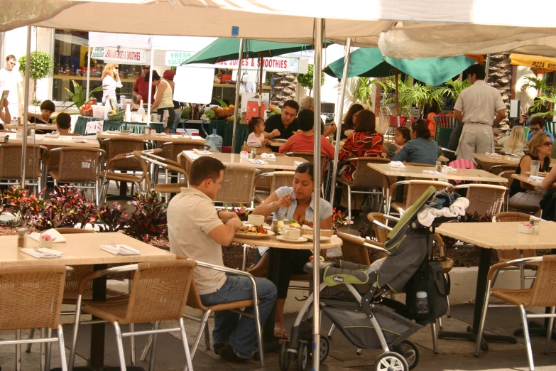 a group of people sitting at a table eating food