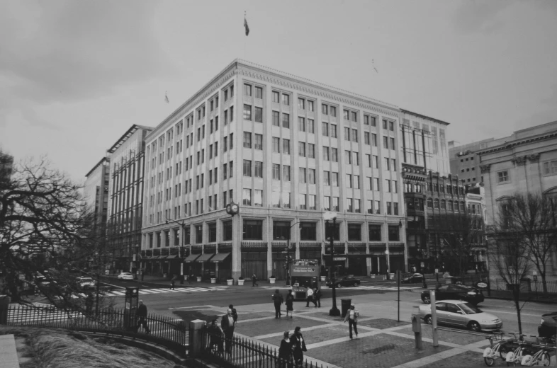 people are standing outside of a large building