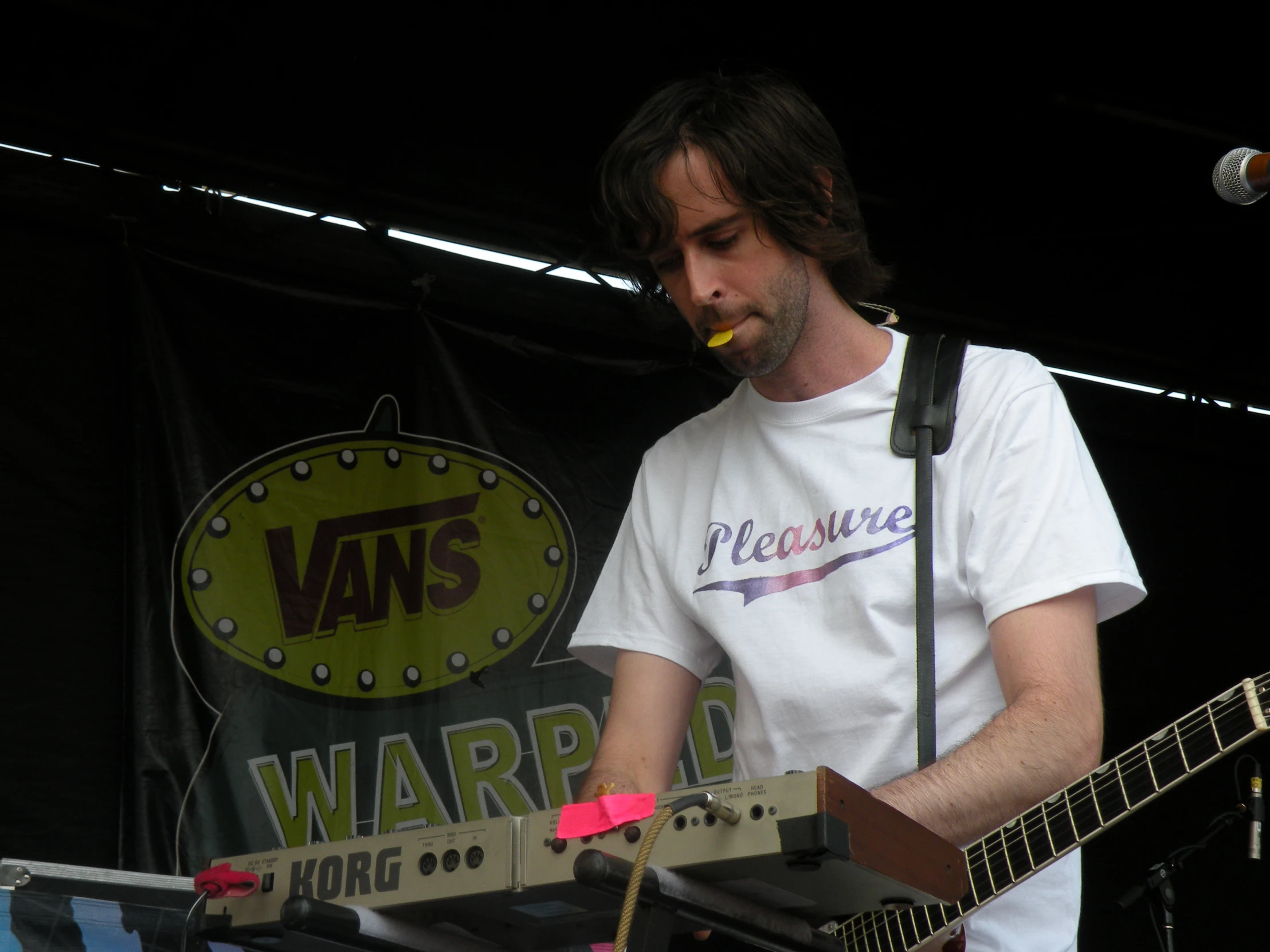 a person that is playing a keyboard in front of a microphone