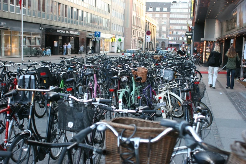 a lot of bikes parked in front of some buildings