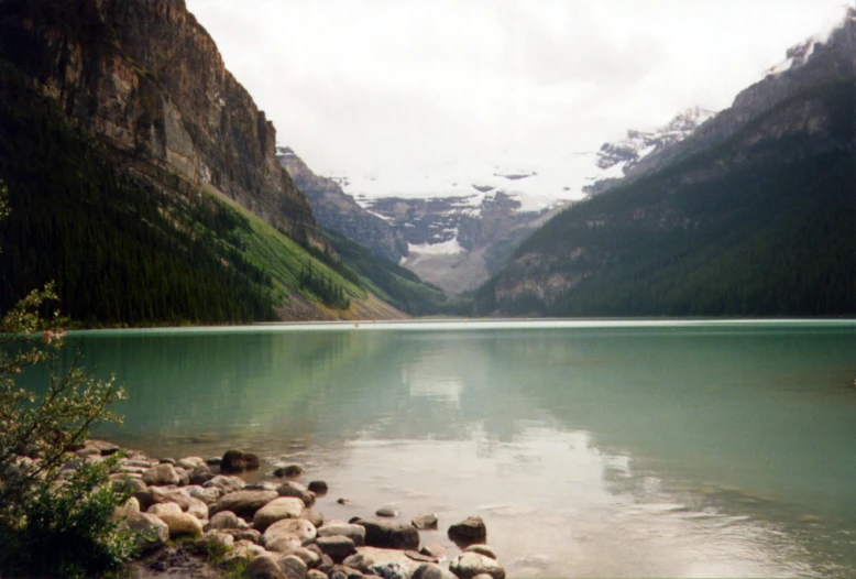 a large lake surrounded by some rocks on a hill