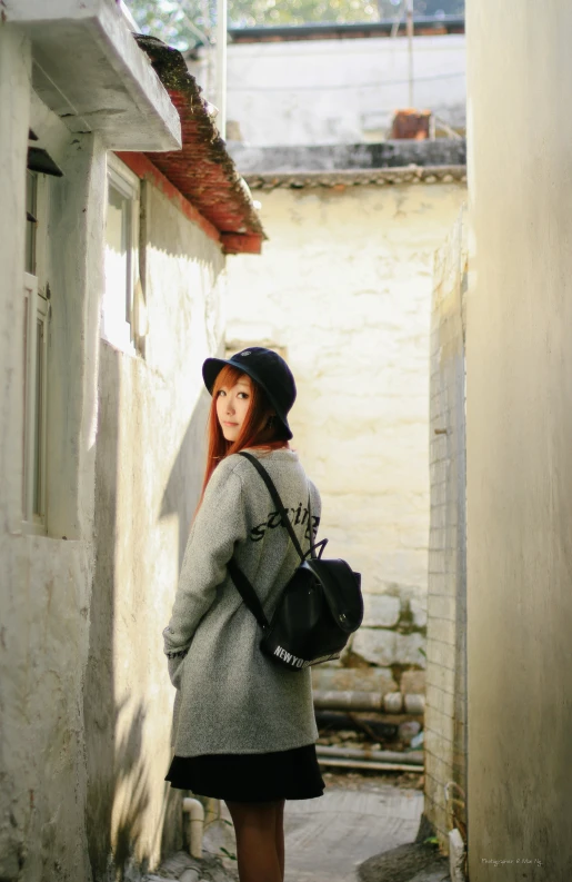 a woman standing outside with her hat on