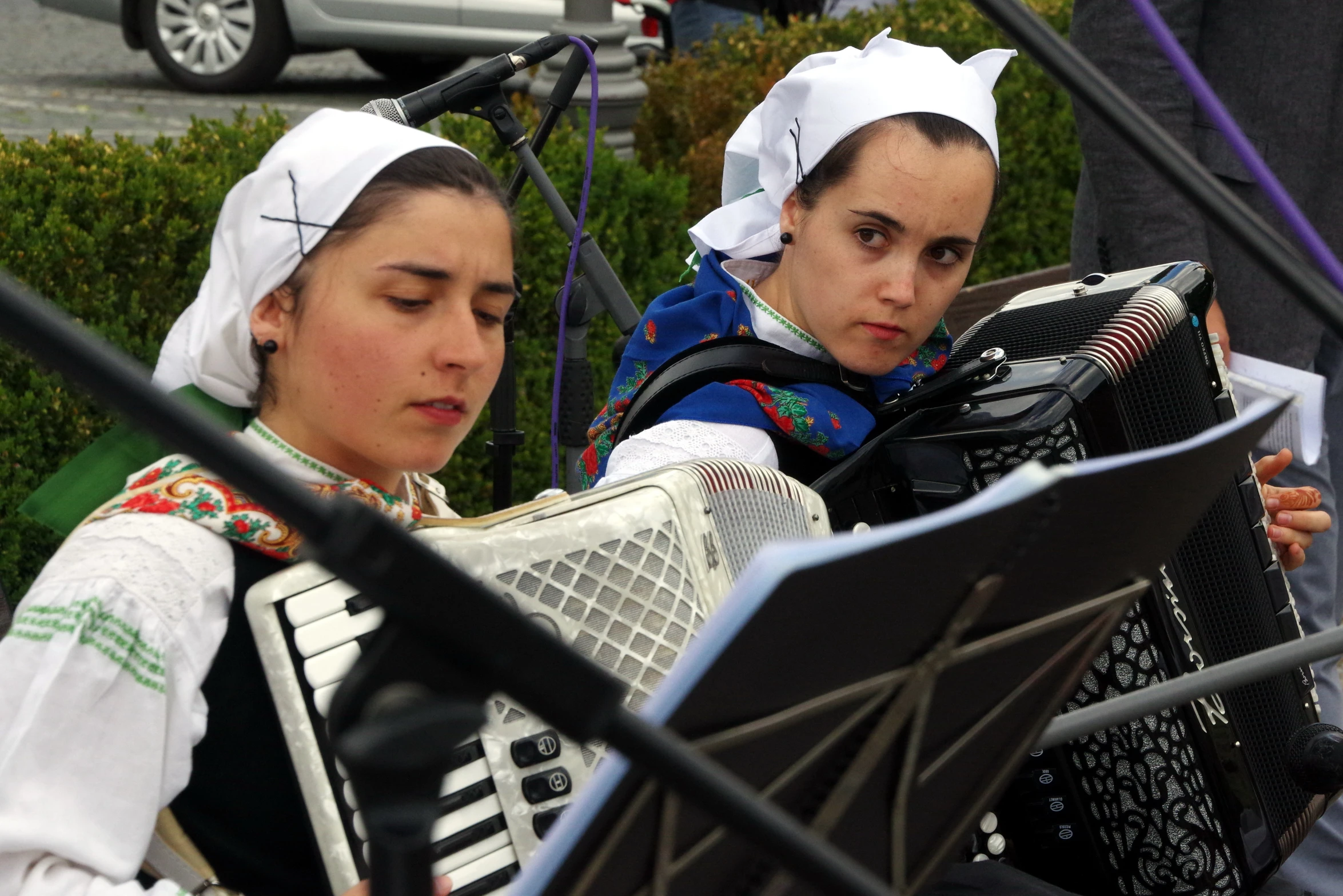 two women who are holding musical instruments near each other